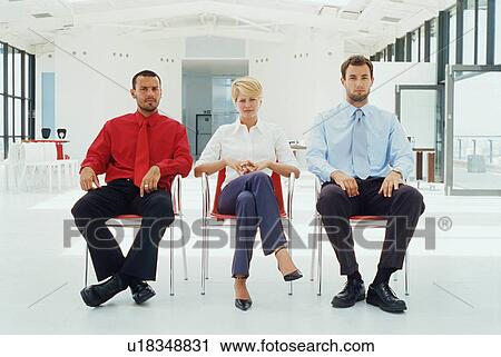 Stock Image - Business people sitting in office. Fotosearch