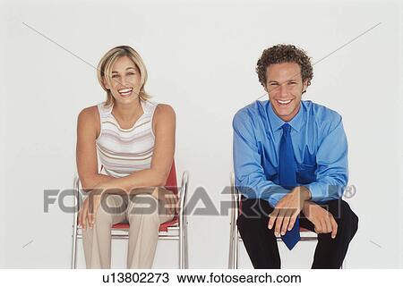 Stock Image - Business people sitting together. Fotosearch