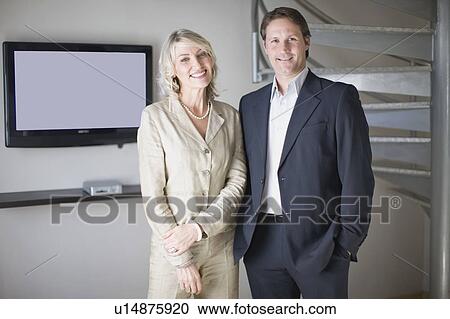 Business people smiling in office View Large Photo Image Stock Image - Business people smiling in office. Fotosearch