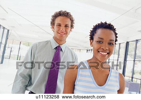 Stock Photo - Business people smiling together. Fotosearch