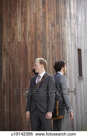 Stock Photography - Business people standing in courtyard. Fotosearch