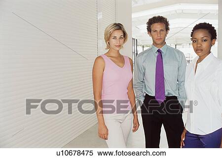 Stock Photography - Business people standing in office. Fotosearch