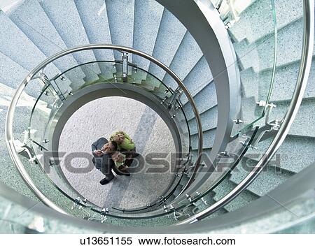 Business people standing in stairwell View Large Photo Image Stock Photography - Business people standing in stairwell. Fotosearch