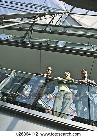 Business people standing on balcony View Large Photo Image Stock Image - Business people standing on balcony. Fotosearch