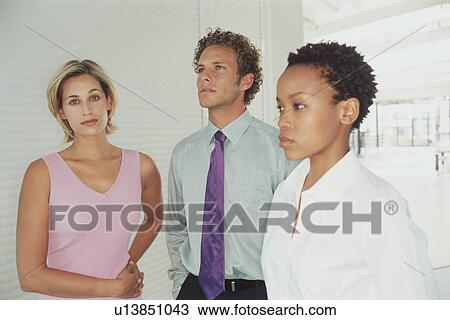 Stock Image - Business people standing together. Fotosearch