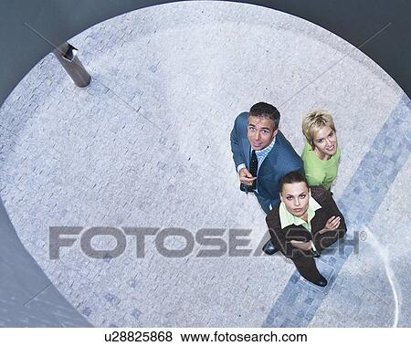 Business people standing together View Large Photo Image Stock Photo - Business people standing together. Fotosearch
