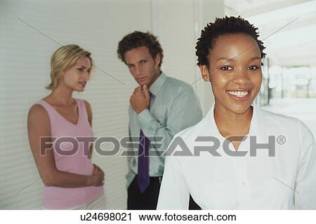Stock Image - Business people talking about colleague. Fotosearch
