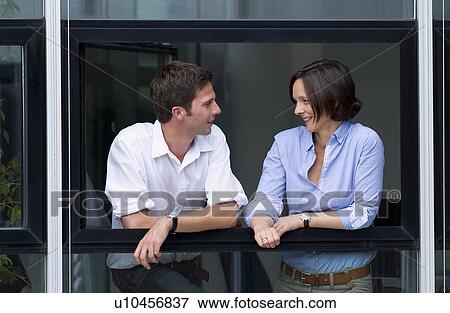 Stock Photo - Business people talking at office window. Fotosearch