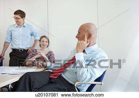 Stock Image - Business people talking in conference. Fotosearch