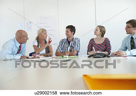 Stock Photo - Business people talking in conference. Fotosearch