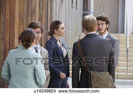 Business people talking in courtyard View Large Photo Image Picture - Business people talking in courtyard. Fotosearch