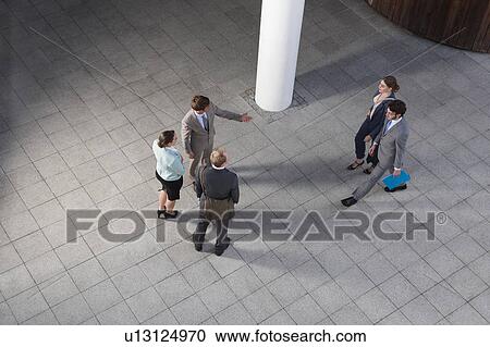 Business people talking in courtyard View Large Photo Image Stock Image - Business people talking in courtyard. Fotosearch