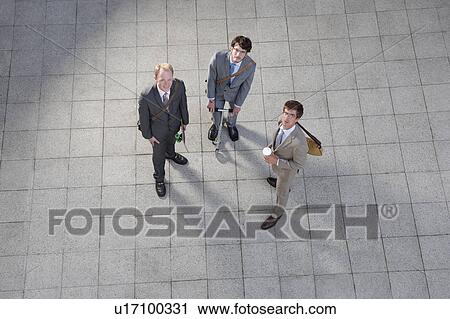 Stock Image - Business people talking in courtyard. Fotosearch