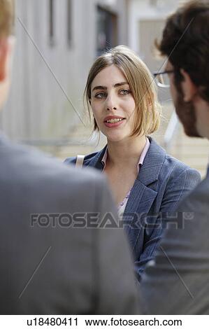 Business people talking in courtyard View Large Photo Image Stock Image - Business people talking in courtyard. Fotosearch