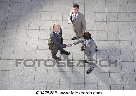 Stock Photograph - Business people talking in courtyard. Fotosearch