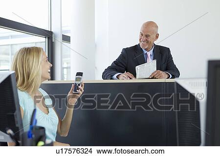 Picture - Business people talking in office. Fotosearch