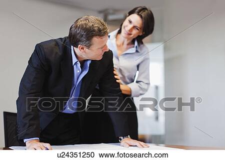 Stock Image - Business people talking in office. Fotosearch