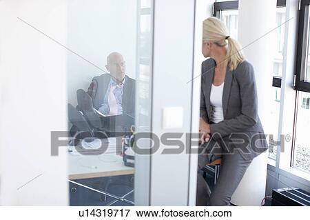 Stock Photo - Business people talking in office. Fotosearch