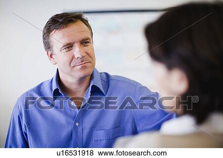 Stock Photo - Business people talking in office. Fotosearch