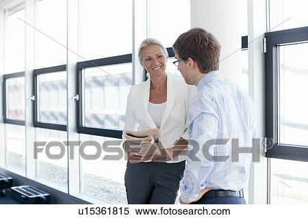 Stock Photography - Business people talking in office. Fotosearch