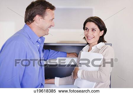 Stock Photography - Business people talking in office. Fotosearch