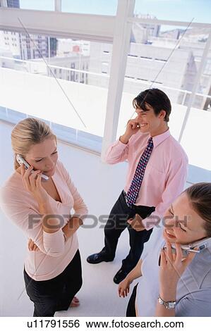 Stock Photograph - Business people talking on cell phones. Fotosearch
