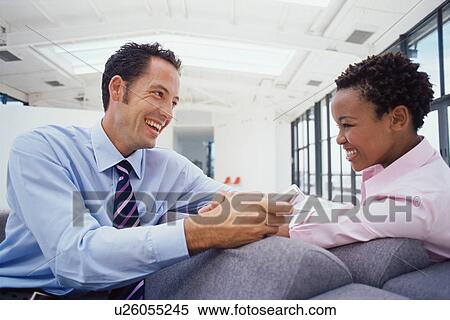 Stock Photography - Business people talking on couch. Fotosearch