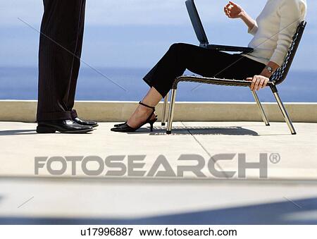 Stock Photo - Business people talking on rooftop. Fotosearch