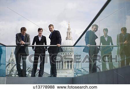 Business people talking on walkway View Large Photo Image Stock Photo - Business people talking on walkway. Fotosearch