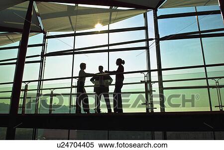Stock Photography - Business people talking on walkway. Fotosearch