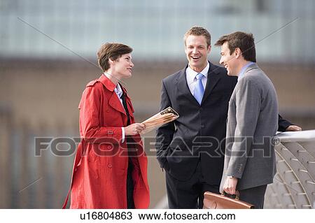 Stock Image - Business people talking outdoors. Fotosearch