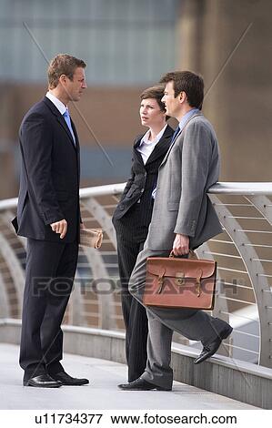 Stock Photo - Business people talking outdoors. Fotosearch