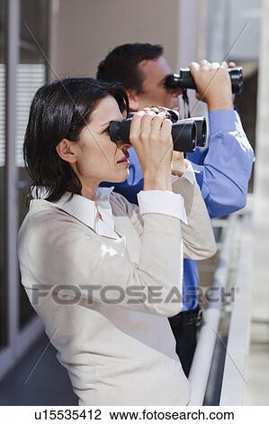 Business people using binoculars View Large Photo Image Stock Image - Business people using binoculars. Fotosearch