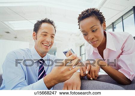 Business people using cell phone View Large Photo Image Stock Photo - Business people using cell phone. Fotosearch