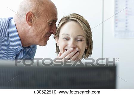 Stock Image - Business people using computer in office. Fotosearch