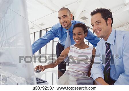 Business people using computer View Large Photo Image Stock Photo - Business people using computer. Fotosearch