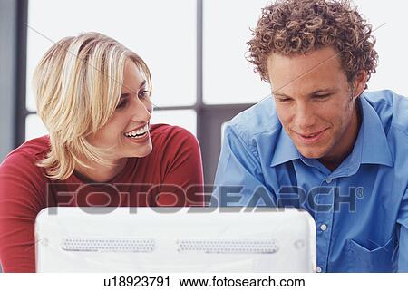 Business people using computer together View Large Photo Image Stock Image - Business people using computer together. Fotosearch