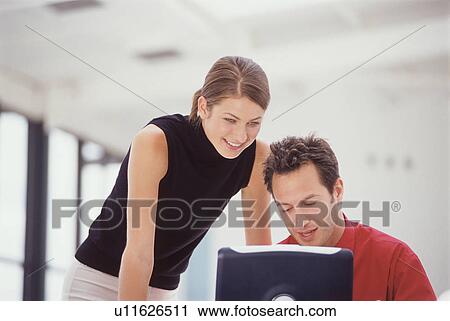 Business people using laptop together View Large Photo Image Stock Image - Business people using laptop together. Fotosearch