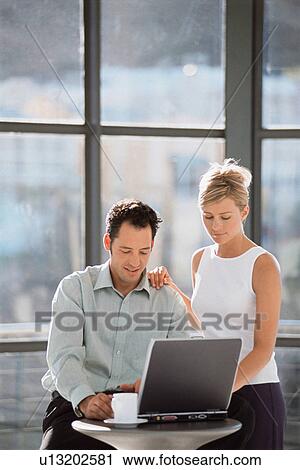 Business people using laptop together View Large Photo Image Stock Image - Business people using laptop together. Fotosearch