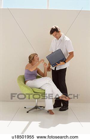 Stock Photography - Business people using laptop together. Fotosearch