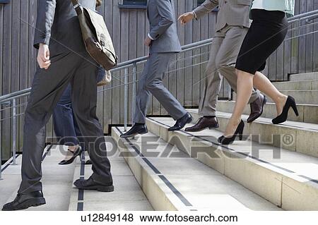 Stock Photo - Business people walking down steps. Fotosearch