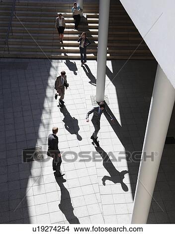 Picture - Business people walking in courtyard. Fotosearch