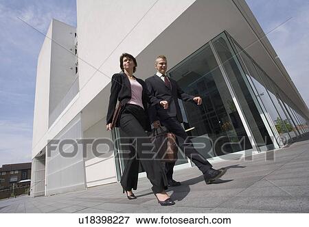 Business people walking in courtyard View Large Photo Image Stock Photo - Business people walking in courtyard. Fotosearch
