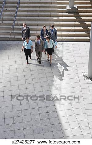 Business people walking in courtyard View Large Photo Image Stock Photo - Business people walking in courtyard. Fotosearch
