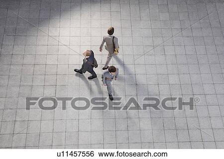 Business people walking in courtyard View Large Photo Image Stock Photograph - Business people walking in courtyard. Fotosearch