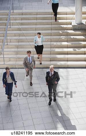 Business people walking in courtyard View Large Photo Image Stock Photography - Business people walking in courtyard. Fotosearch