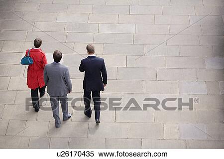 Business people walking in courtyard View Large Photo Image Stock Photography - Business people walking in courtyard. Fotosearch