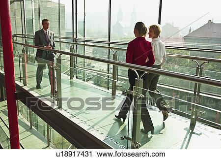 Business people walking on walkway View Large Photo Image Stock Image - Business people walking on walkway. Fotosearch