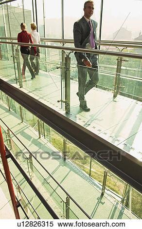 Business people walking on walkway View Large Photo Image Stock Photography - Business people walking on walkway. Fotosearch