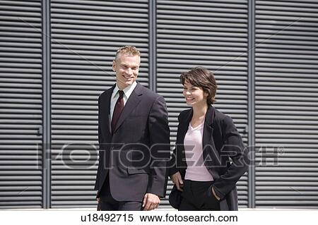 Stock Photography - Business people walking outside building. Fotosearch